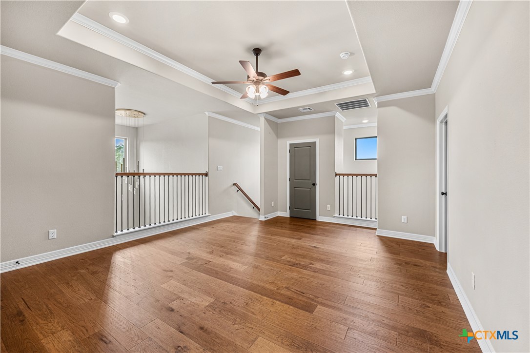 2136 Oak Draw Court Belton, TX 76513 - Photo 24 of 46 an empty room with wooden floor ceiling fan and windows
