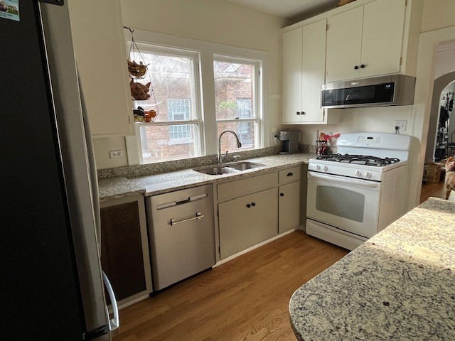 3016 Thayer Street Evanston, IL 60201 - Photo 7 of 20 a kitchen with stainless steel appliances granite countertop a stove a sink and a microwave
