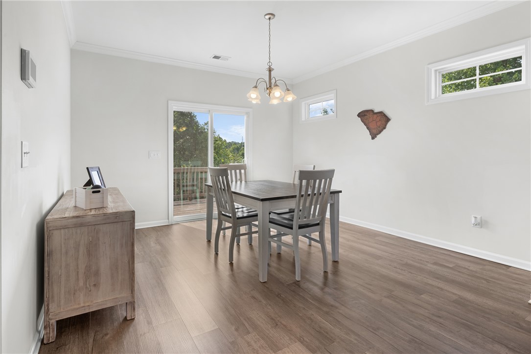 768 Rocky Ridge Circle Seneca, SC 29678 - Photo 6 of 30 Dining area with hardwood flooring and ample natural light from the sliding glass door.
