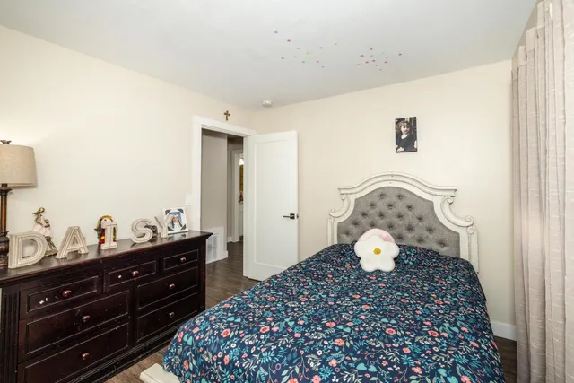 a bed room with a bed and a chair