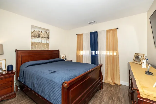 a bed sitting in a bedroom next to a window