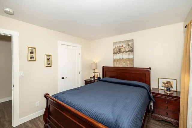 a room with a bed and dresser