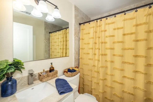 a bathroom with a sink toilet and shower