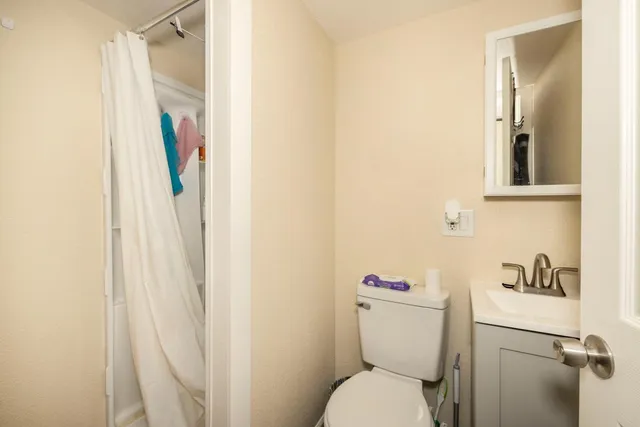 a white toilet sitting next to a bathroom sink