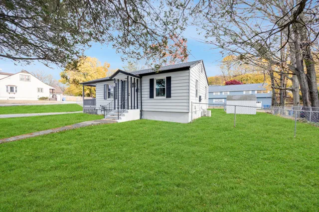 a front view of house with yard and green space
