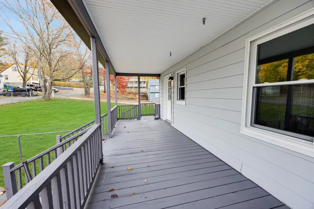 a view of a deck with wooden floor and garden