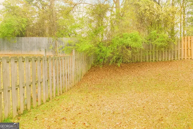 a view of swimming pool with wooden fence