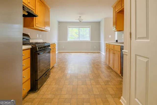 a kitchen with stainless steel appliances granite countertop a stove and a refrigerator
