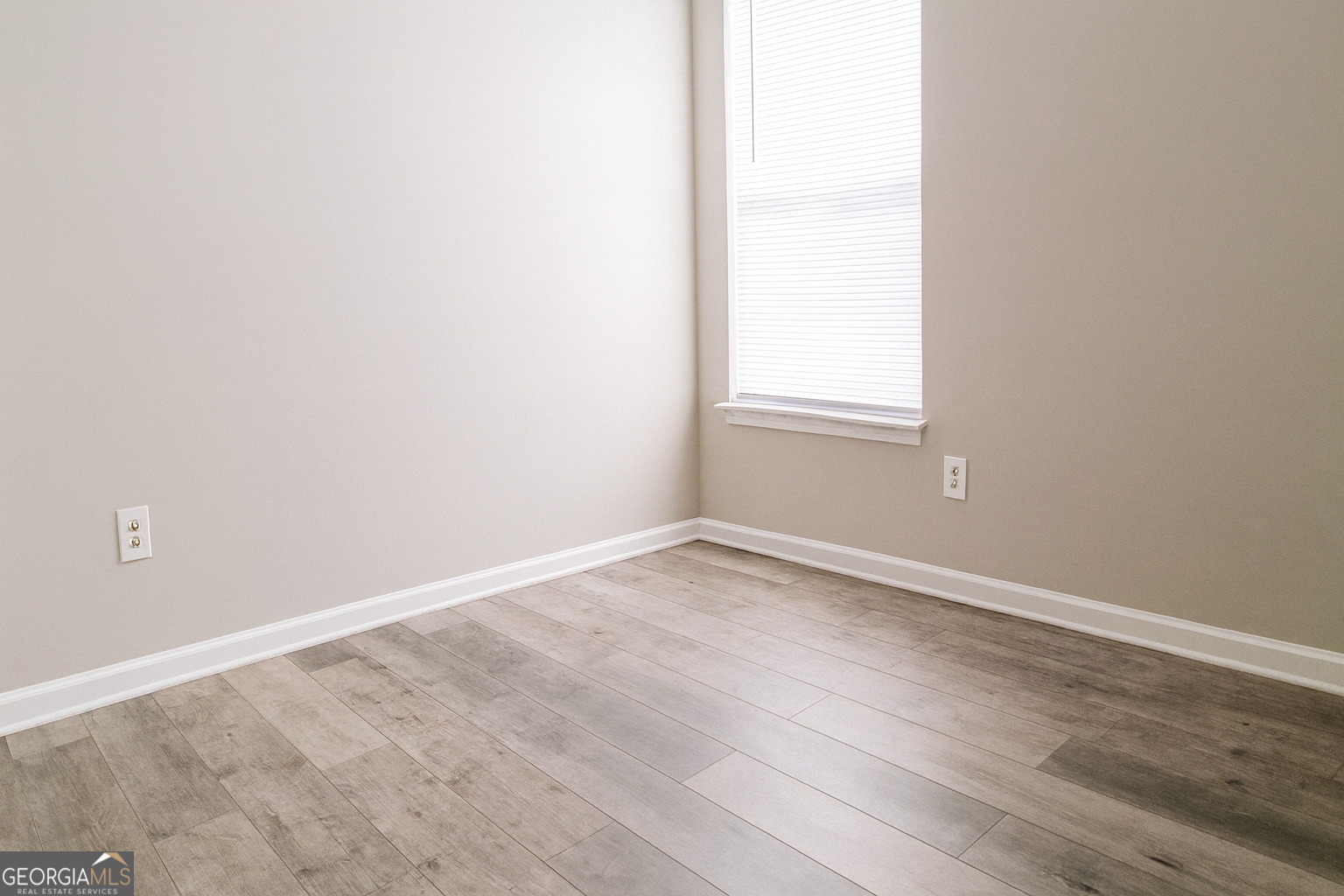 8596 Guthrie Drive Riverdale, GA 30274 - Photo 10 of 14 an empty room with wooden floor and windows