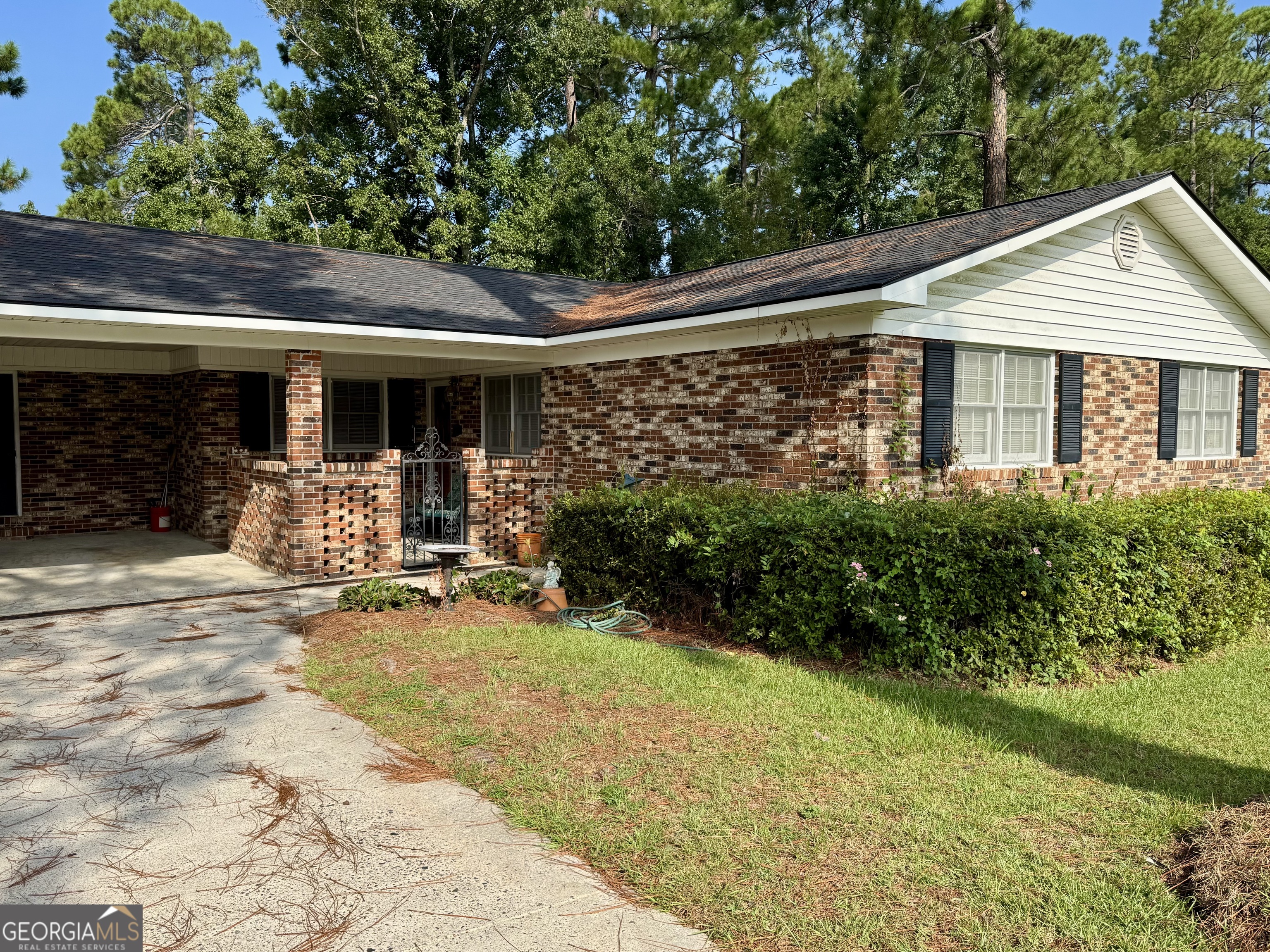 105 Pine Circle Sylvania, GA 30467 - Photo 1 of 1 a front view of a house with garden and porch