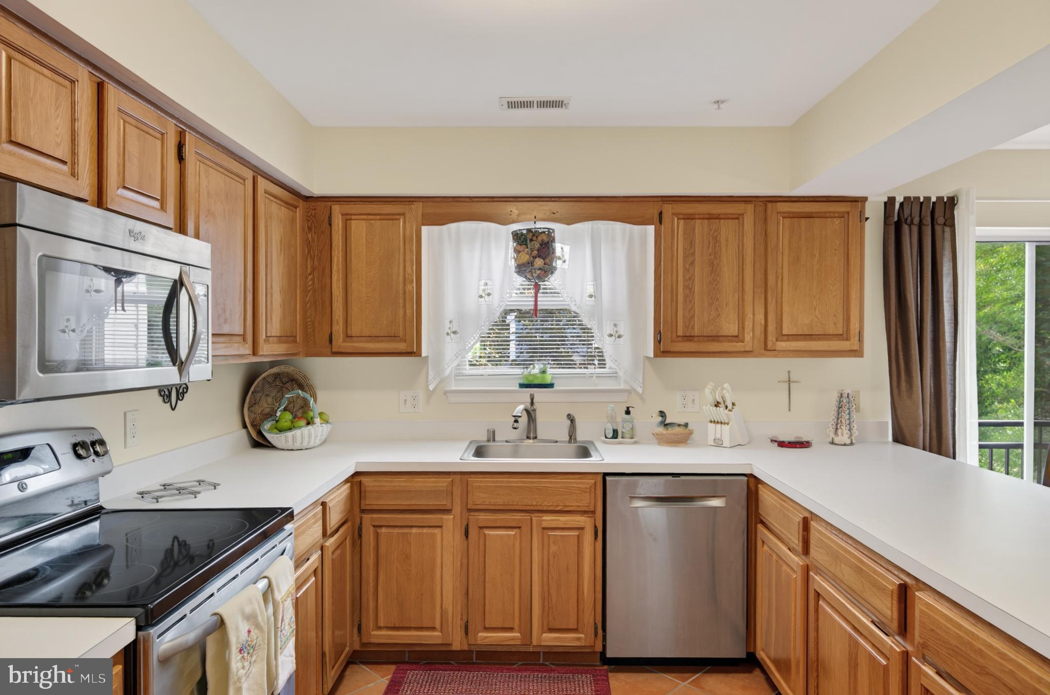 936 Bay Ridge Avenue, Unit 201 Annapolis, MD 21403 - Photo 20 of 40 a kitchen with stainless steel appliances granite countertop a sink stove and cabinets
