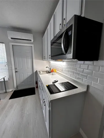 a kitchen that has a sink and a stove in it