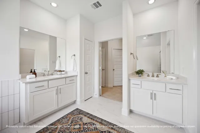 a spacious bathroom with a shower sink and mirror