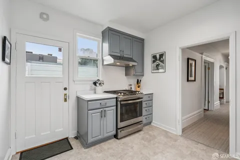 a dining room with kitchen island a table chairs and a shelf