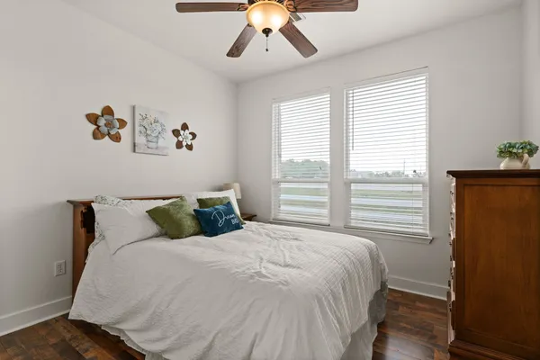 a large bed sitting in a bedroom next to a window
