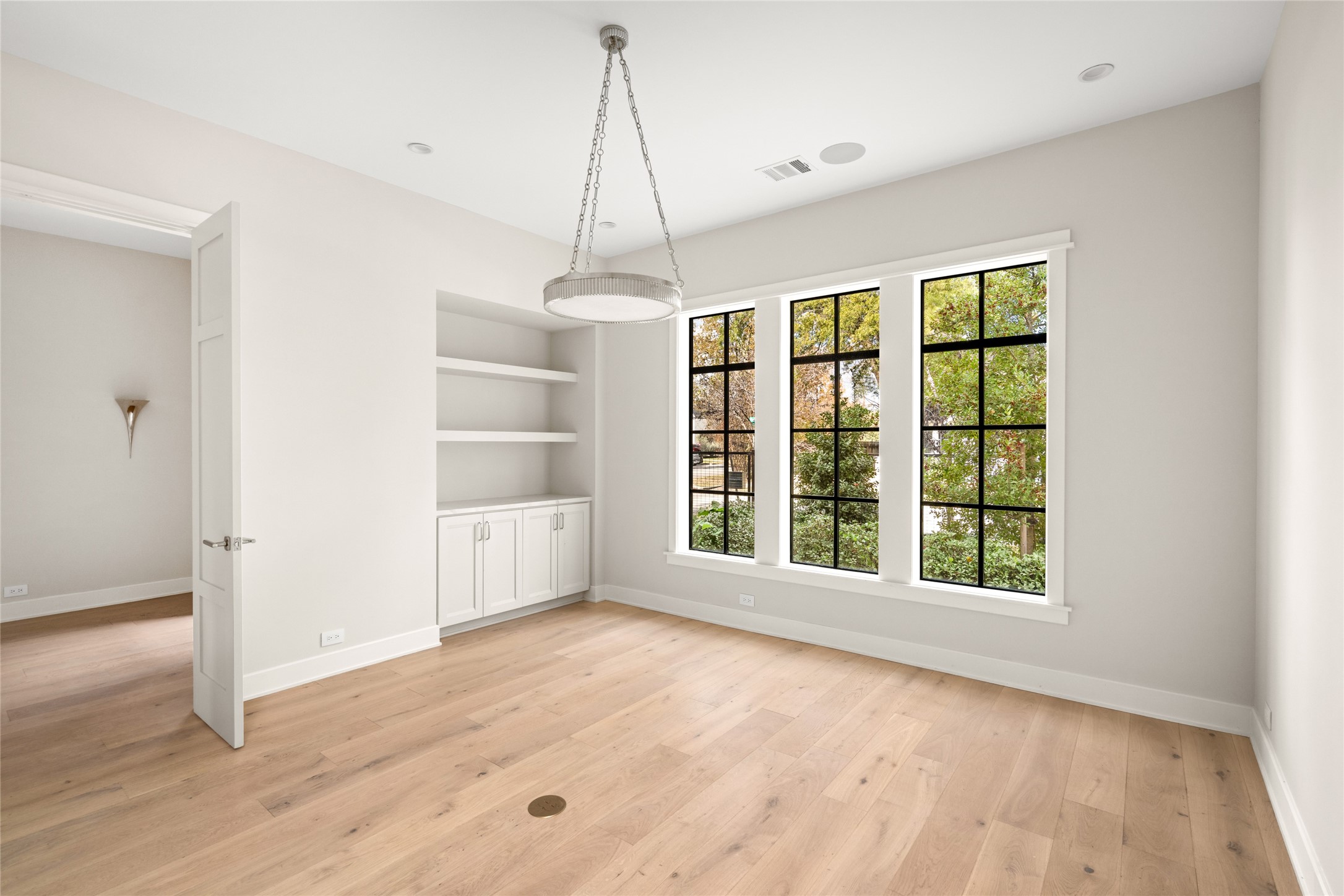 1136 Woodland Street Houston, TX 77009 - Photo 12 of 50 Versatile office with built-in shelving and expansive windows. Also ideal for a formal sitting room, office, or library.