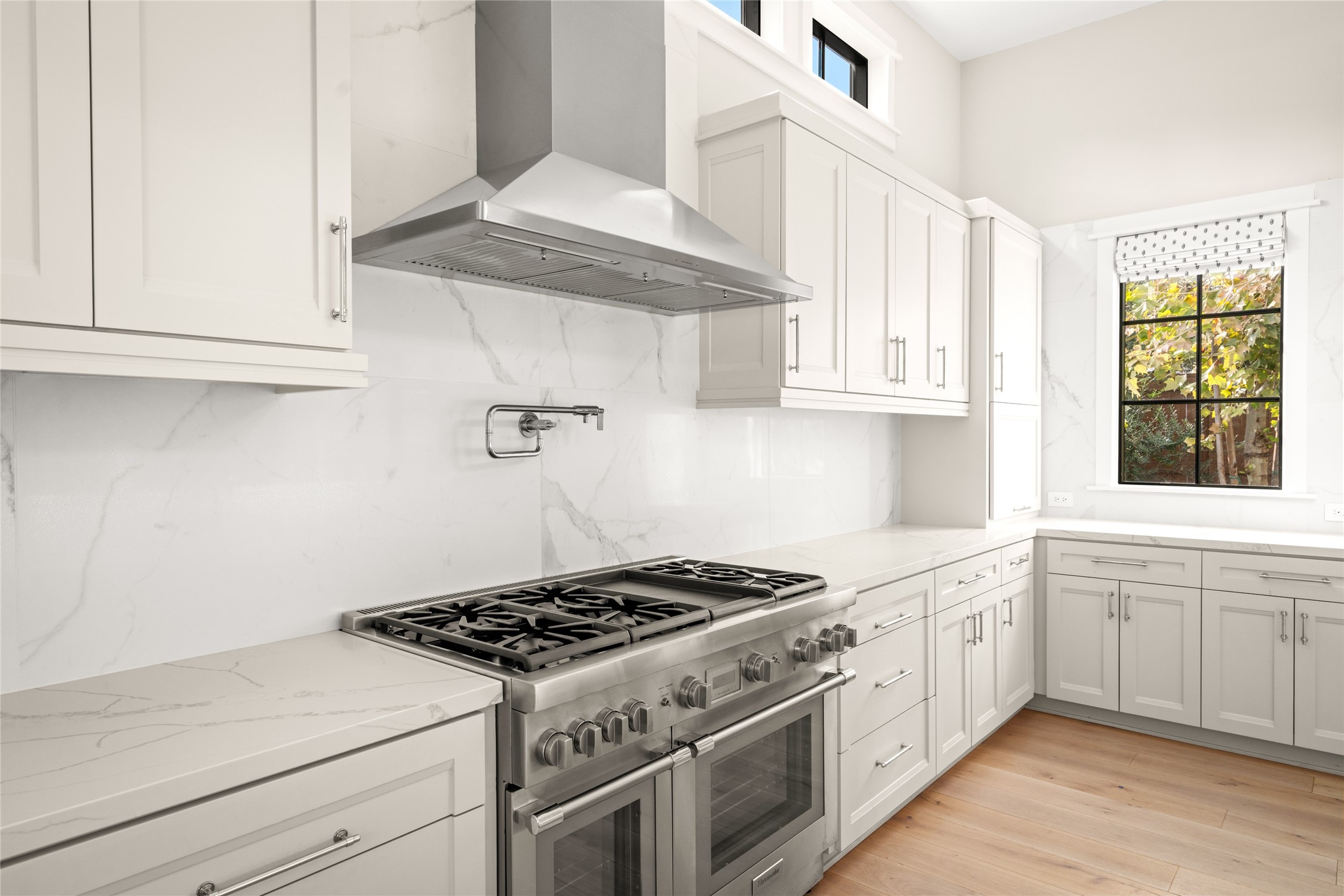 1136 Woodland Street Houston, TX 77009 - Photo 20 of 50 Chef’s kitchen featuring Thermador appliances, double ovens, convection oven, steamer, walk-in pantry, and refined custom details. Open to the living area for effortless entertaining and connection.