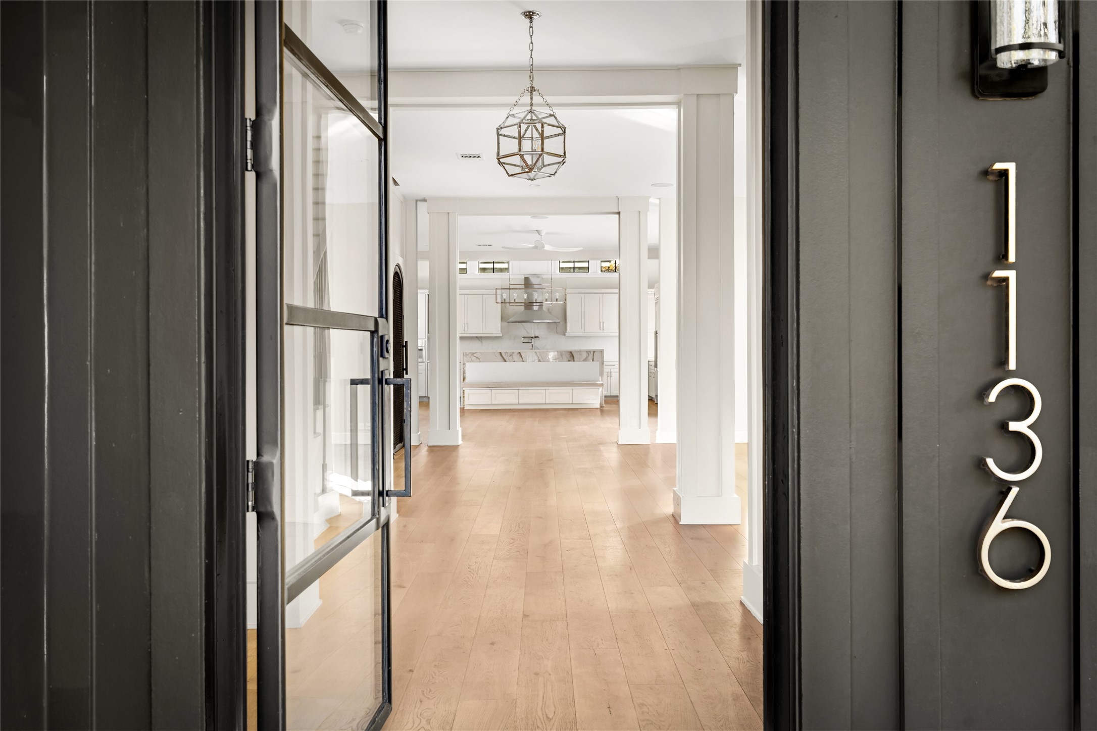 1136 Woodland Street Houston, TX 77009 - Photo 2 of 50 Glass-paneled front door opens to a light-filled interior, offering a seamless transition from exterior architecture to thoughtful design.