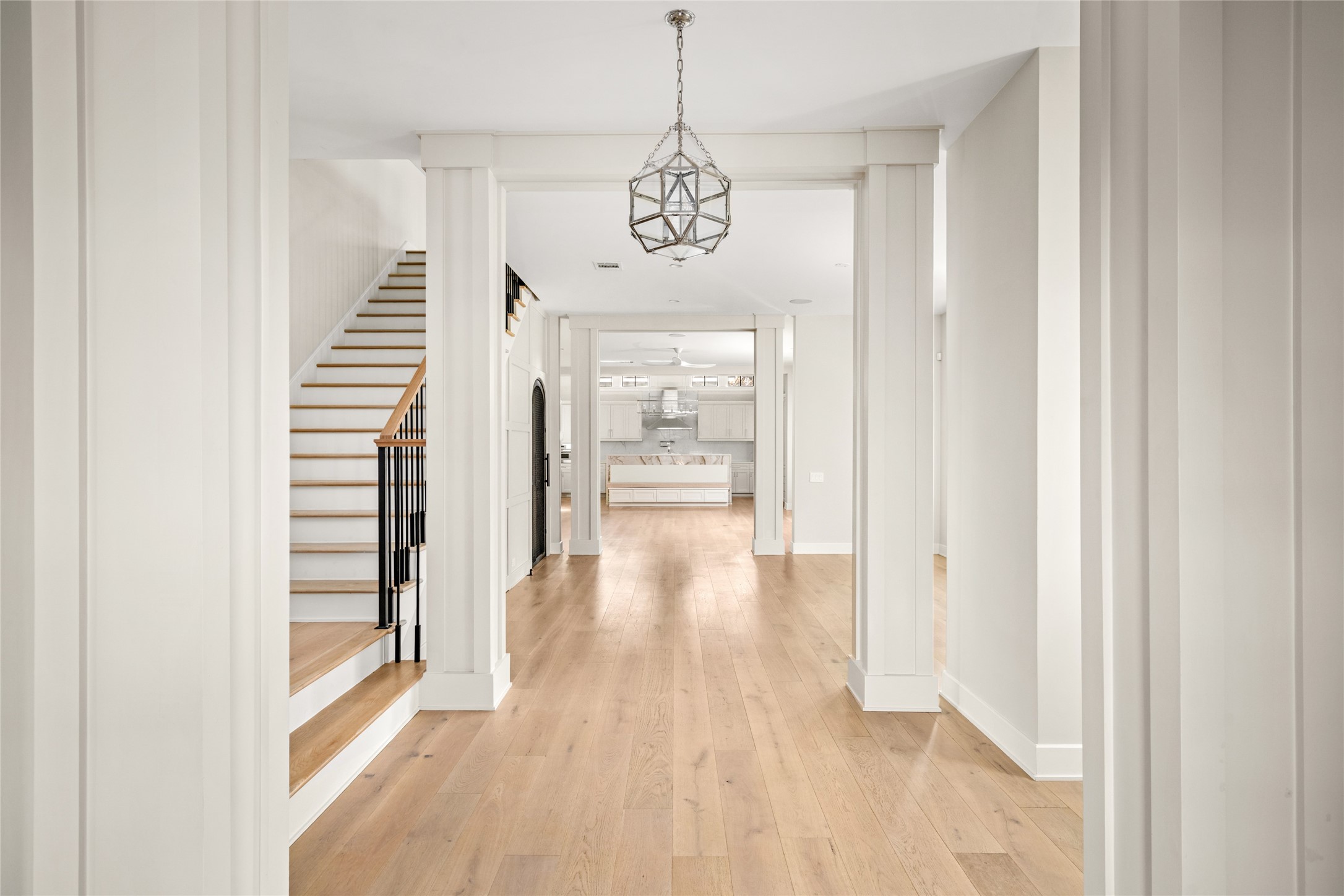 1136 Woodland Street Houston, TX 77009 - Photo 3 of 50 A dramatic, light-filled entry welcomes you with soaring ceilings and gallery-style walls—perfect for showcasing art—setting the tone for the home’s modern sophistication and open flow.