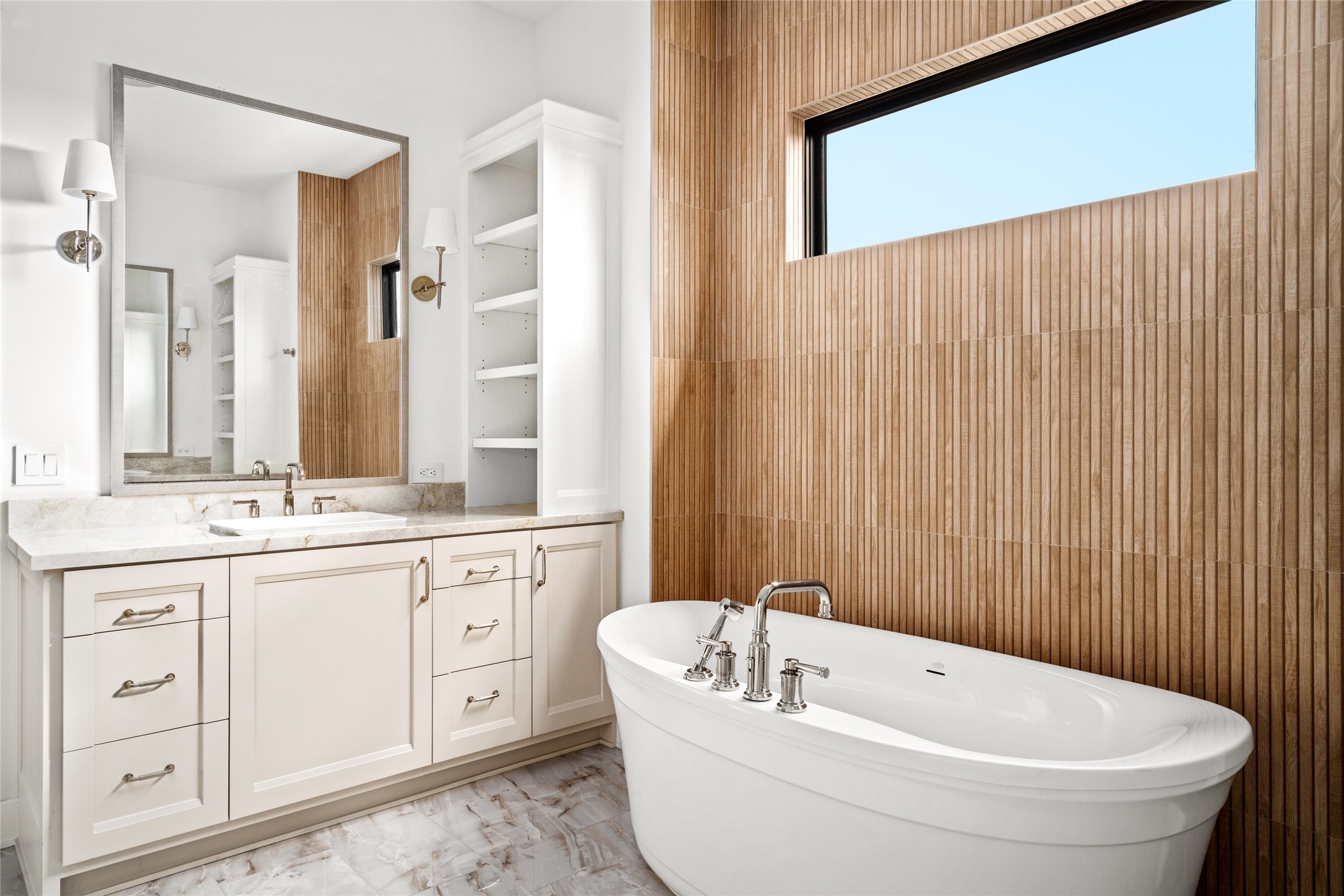 1136 Woodland Street Houston, TX 77009 - Photo 31 of 50 Elegant dual-vanity with stone countertops, framed mirrors, and tailored lighting, positioned alongside the soaking tub for a spa-like experience.