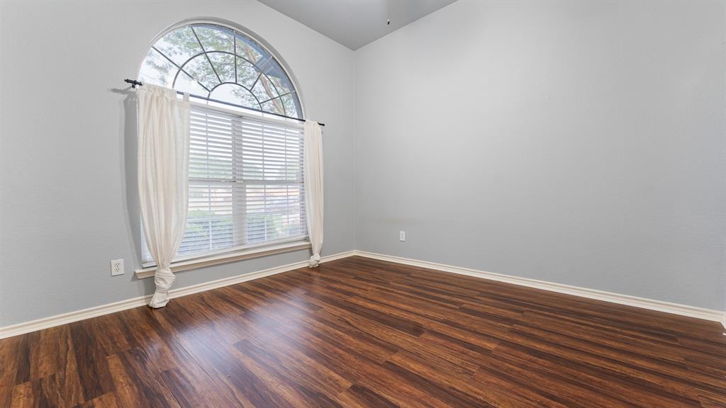 525 Mustang Ridge Drive Murphy, TX 75094 - Photo 11 of 26 a view of empty room with wooden floor and fan