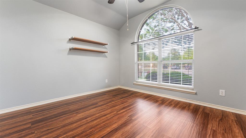 525 Mustang Ridge Drive Murphy, TX 75094 - Photo 13 of 26 a view of an empty room with wooden floor and a window