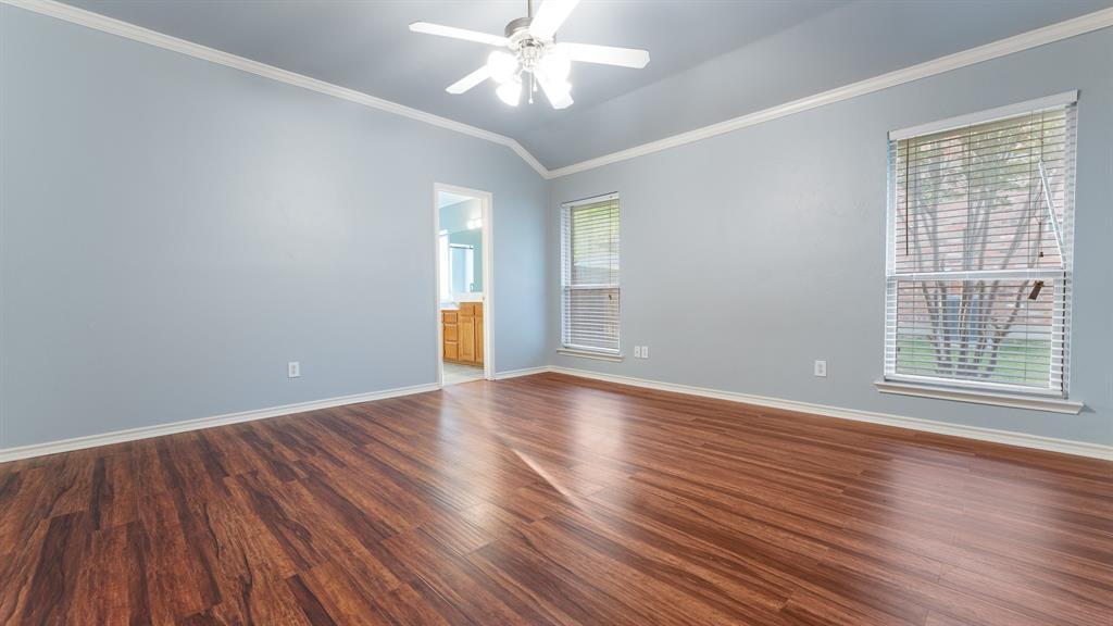525 Mustang Ridge Drive Murphy, TX 75094 - Photo 14 of 26 a view of an empty room with wooden floor and a window