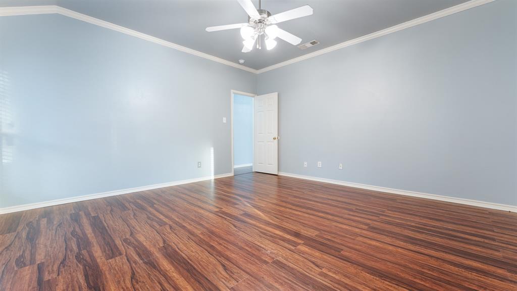 525 Mustang Ridge Drive Murphy, TX 75094 - Photo 15 of 26 a view of an empty room with wooden floor and a ceiling fan