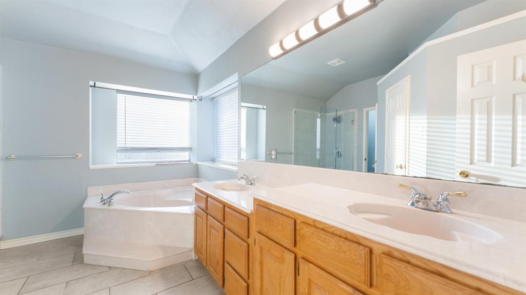 525 Mustang Ridge Drive Murphy, TX 75094 - Photo 17 of 26 a spacious bathroom with sink shower bathtub and window