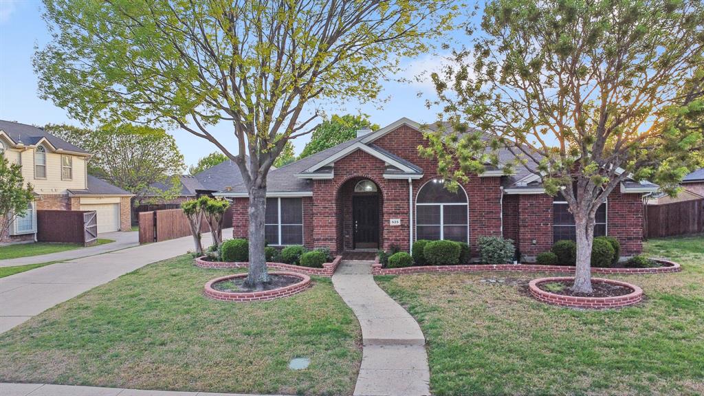 525 Mustang Ridge Drive Murphy, TX 75094 - Photo 22 of 26 a front view of a house with garden and trees
