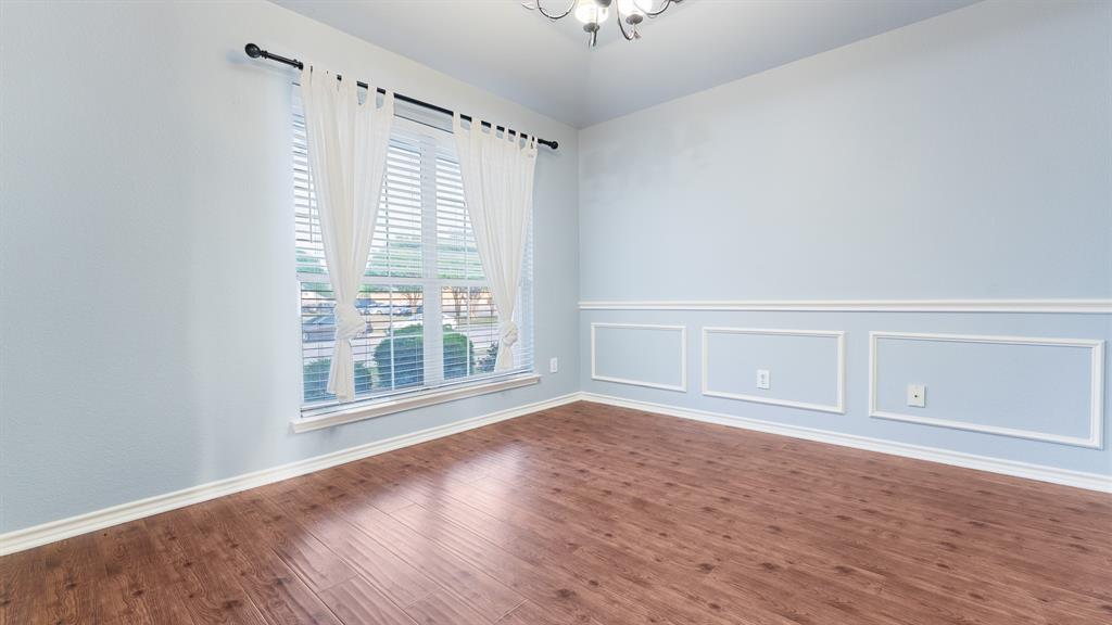 525 Mustang Ridge Drive Murphy, TX 75094 - Photo 7 of 26 a view of an empty room with a window and wooden floor
