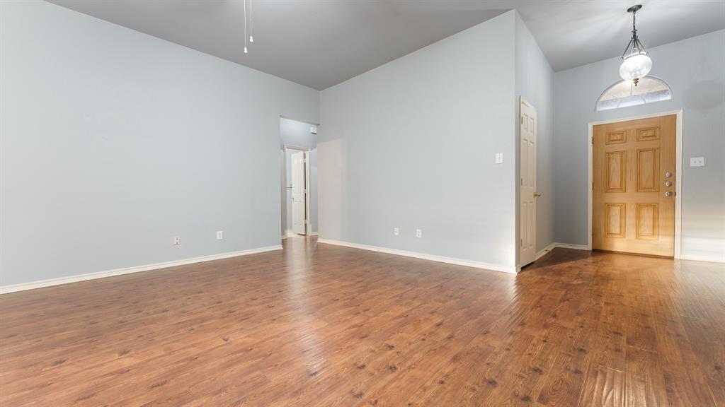 525 Mustang Ridge Drive Murphy, TX 75094 - Photo 9 of 26 a view of an empty room with wooden floor and windows