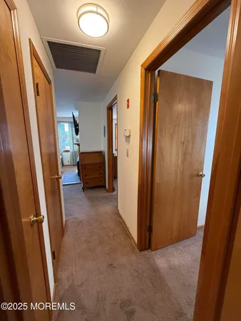 a view of hallway with couch and a gate