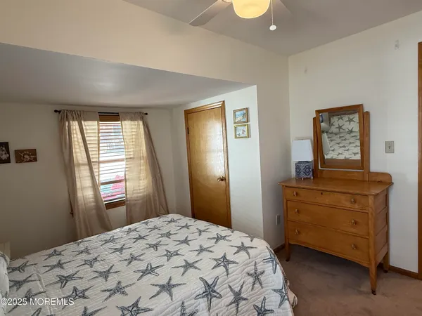a bedroom with a bed and a dresser