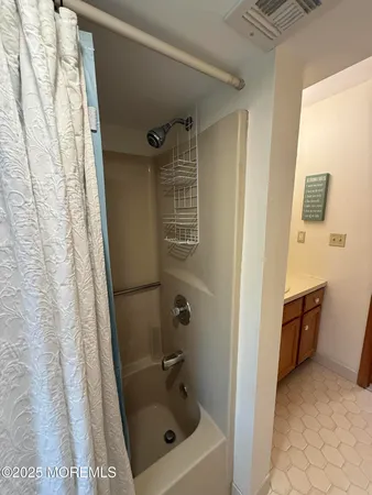 a bathroom with a shower and a tub