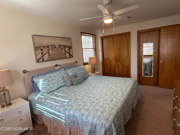 a bedroom with a large bed and a chandelier