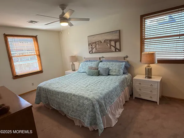 a bedroom with a bed dresser and window