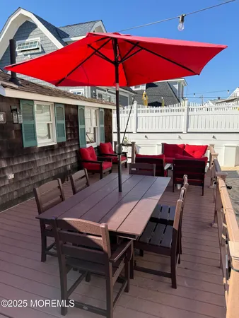 an outdoor sitting area with furniture and umbrella