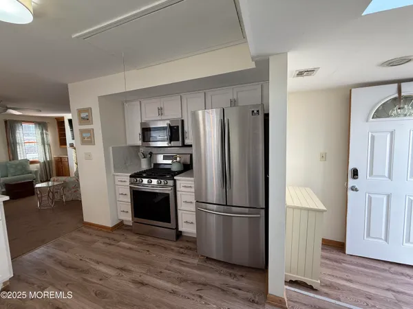 a kitchen with stainless steel appliances a refrigerator and a stove top oven