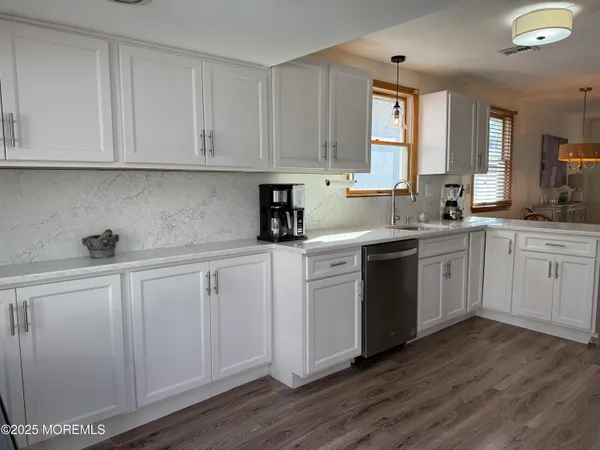 a kitchen with white cabinets sink and white appliances