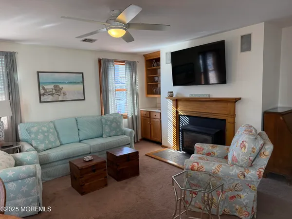 a living room with furniture fireplace and flat screen tv
