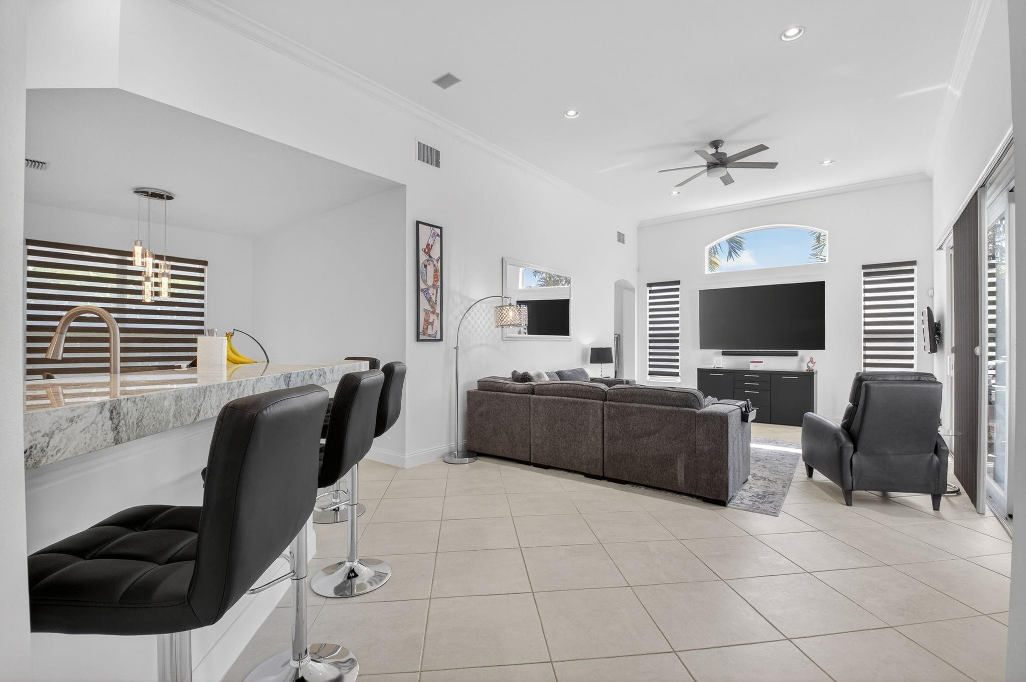 10078 Lexington Estates Boulevard Boca Raton, FL 33428 - Photo 12 of 49 a living room with furniture and a flat screen tv