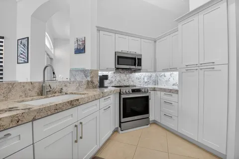 a bathroom with a granite countertop sink mirror and double