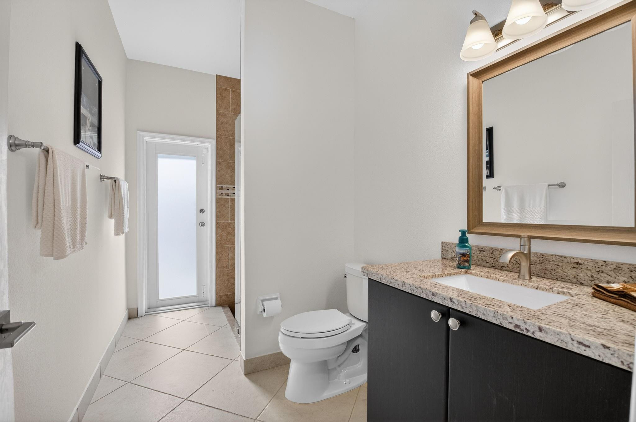 10078 Lexington Estates Boulevard Boca Raton, FL 33428 - Photo 28 of 49 a bathroom with a granite countertop sink toilet a mirror and shower