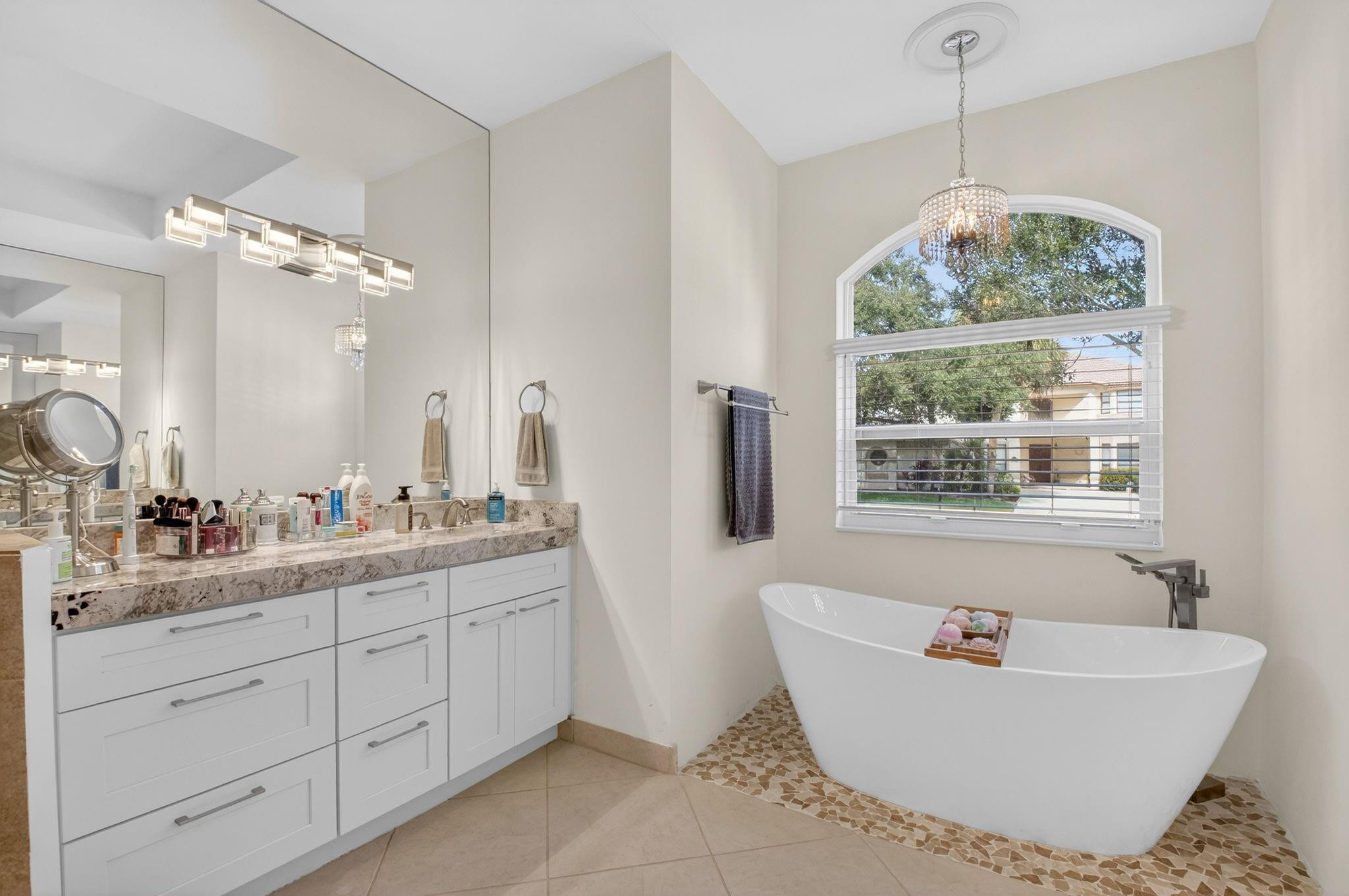 10078 Lexington Estates Boulevard Boca Raton, FL 33428 - Photo 34 of 49 a bathroom with a tub sink and mirror