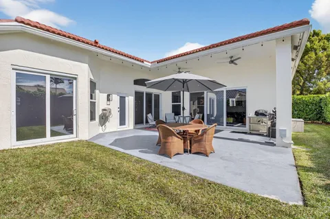 an aerial view of residential houses with outdoor space and trees