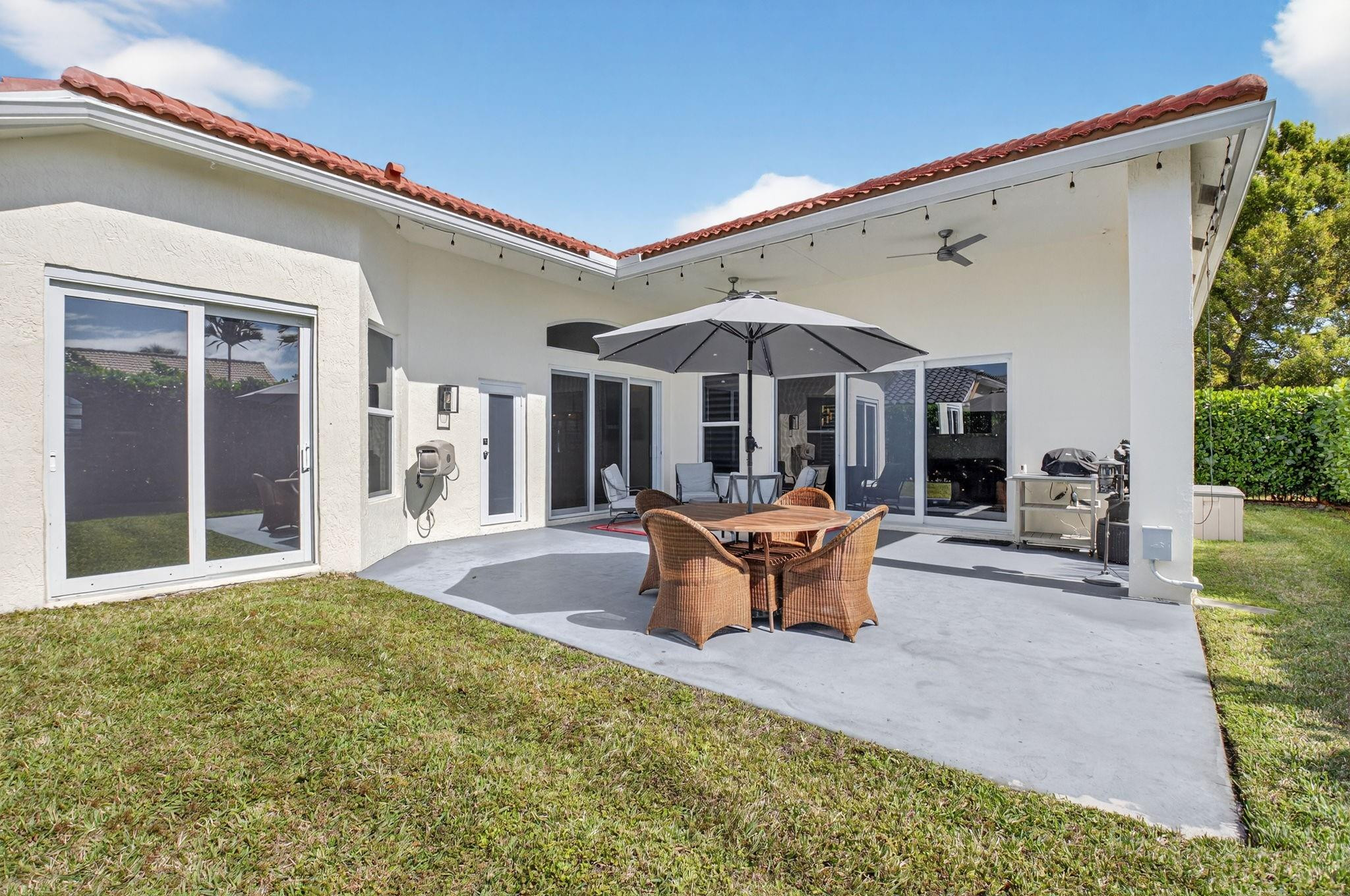 10078 Lexington Estates Boulevard Boca Raton, FL 33428 - Photo 39 of 49 a patio with a table and chairs and potted plants