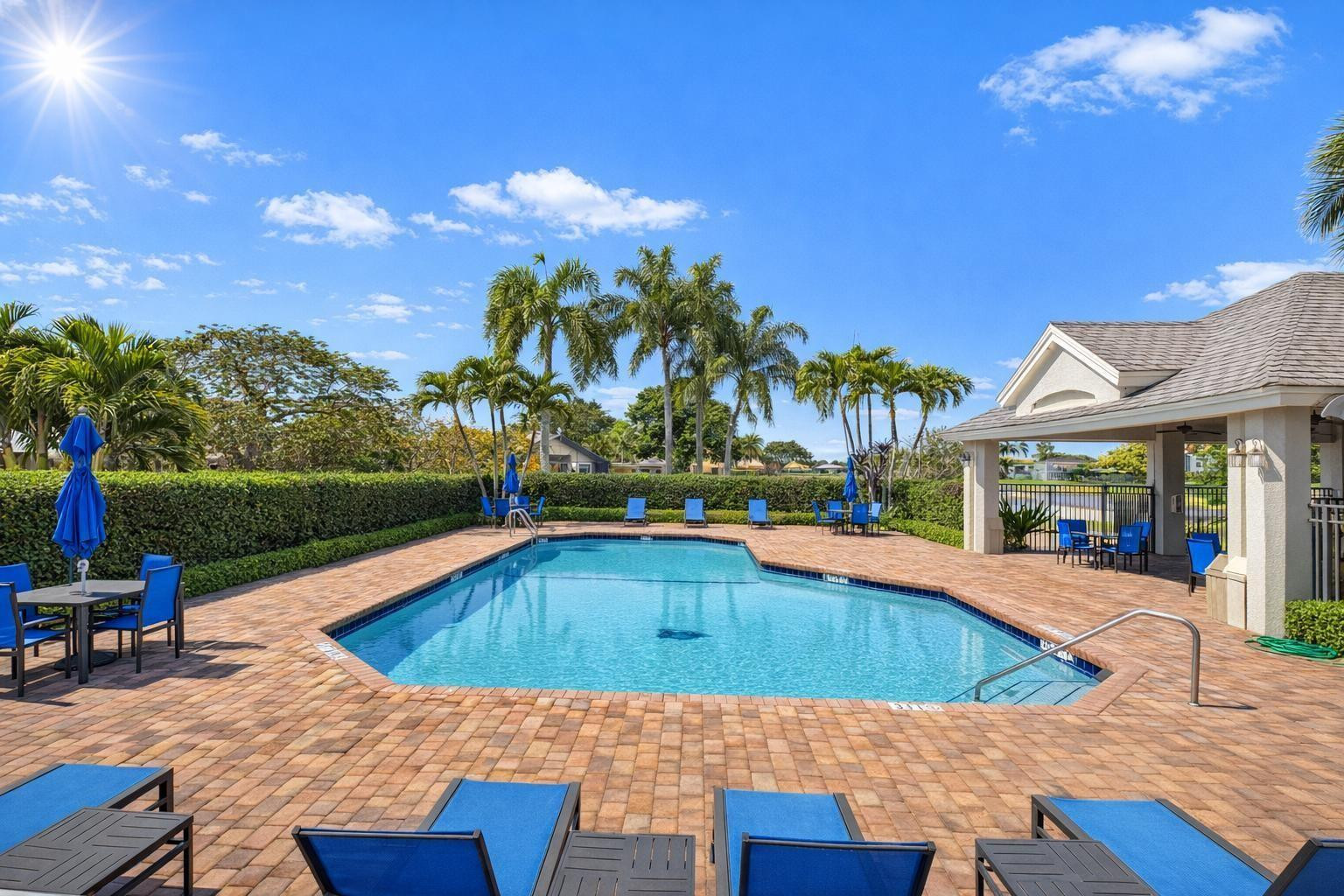 10078 Lexington Estates Boulevard Boca Raton, FL 33428 - Photo 48 of 49 a view of swimming pool with lounge chair and dinning table under an umbrella