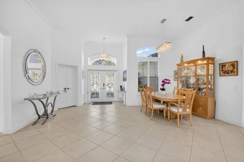 a view of a dining room with furniture and a chandelier