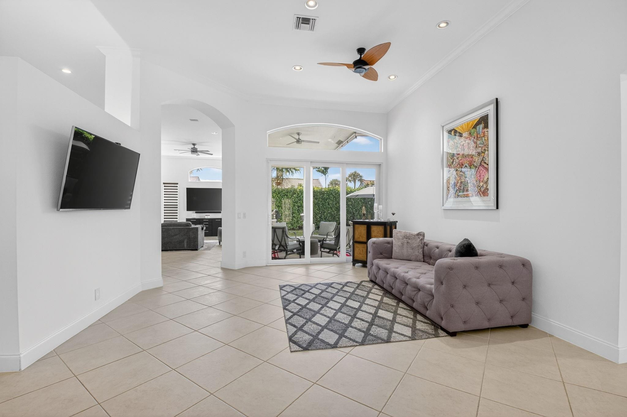 10078 Lexington Estates Boulevard Boca Raton, FL 33428 - Photo 9 of 49 a living room with furniture and a flat screen tv